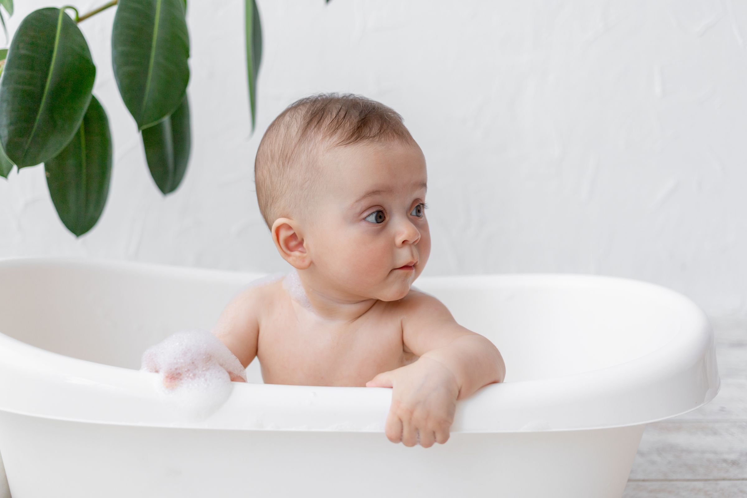 Small Child Boy 8 Months Old Bathes Bath With Foam Soap Bubbles