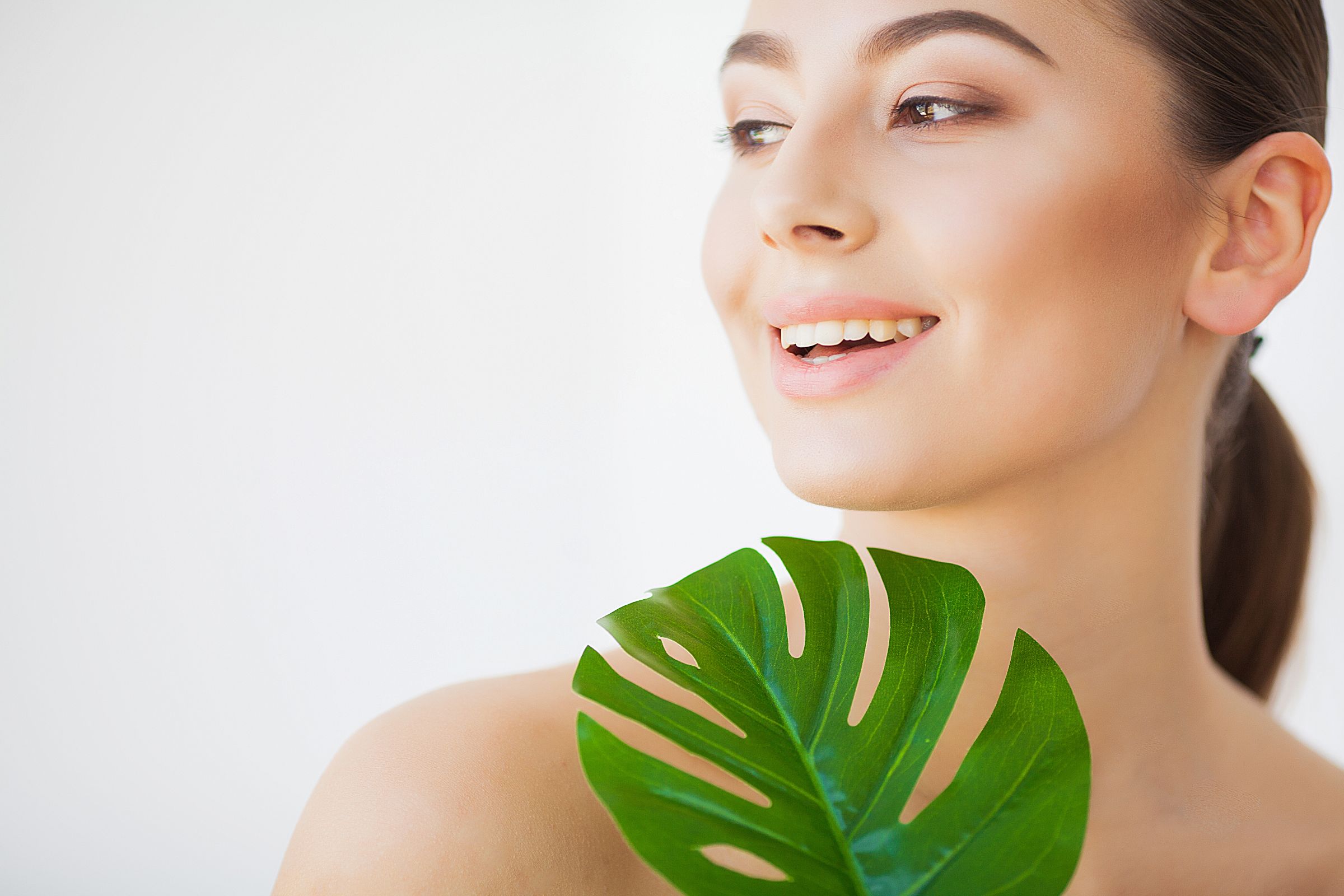 Spa Care Young Pretty Brunette Woman With Big Green Leaf